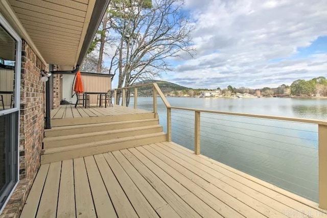 exterior space with a deck with water view