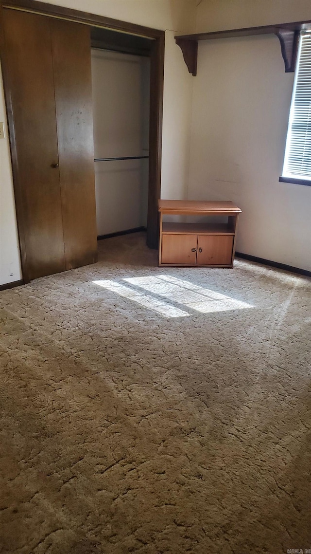 unfurnished bedroom featuring a closet and carpet