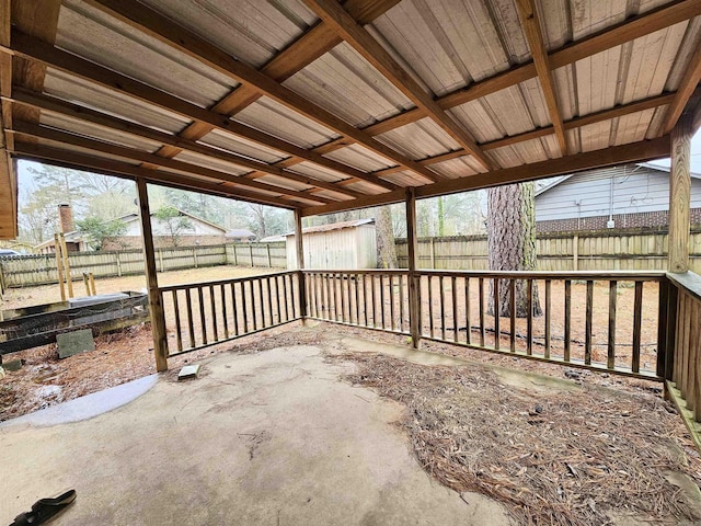 view of patio / terrace featuring an outbuilding, a shed, and a fenced backyard