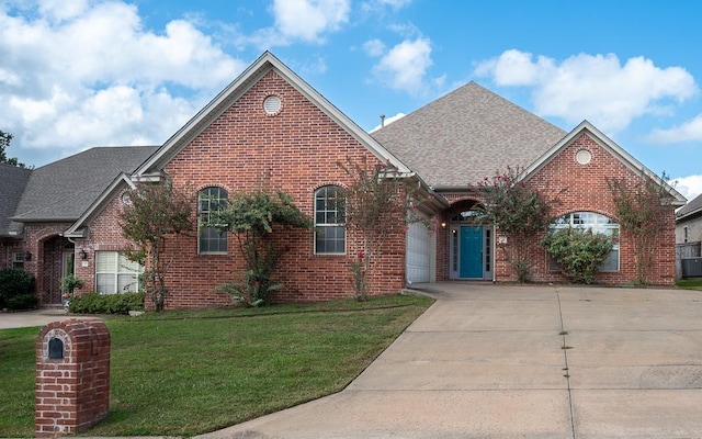 view of property featuring a front yard and a garage