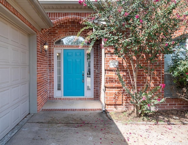 view of exterior entry with a garage