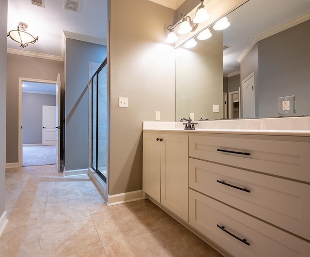 bathroom with ornamental molding, vanity, tile patterned flooring, and a shower with shower door