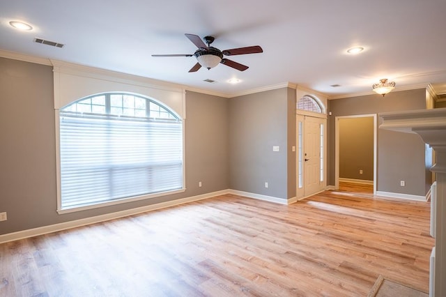 spare room with ornamental molding, ceiling fan, and light hardwood / wood-style flooring