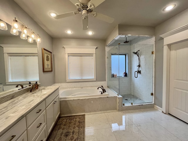 full bathroom with a stall shower, a garden tub, a ceiling fan, and vanity