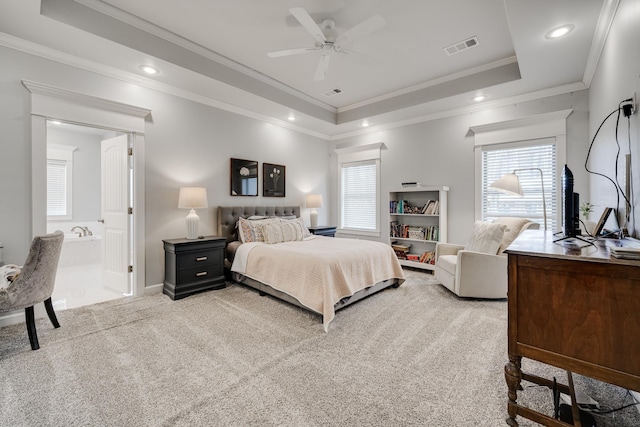 carpeted bedroom featuring a tray ceiling, visible vents, and crown molding