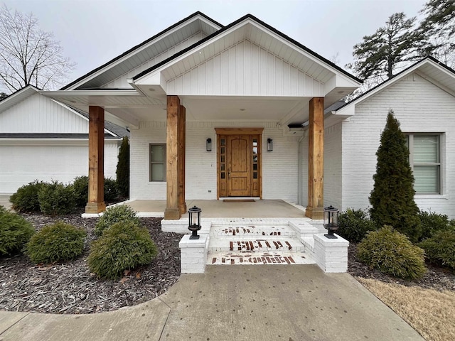 view of front facade with covered porch and brick siding