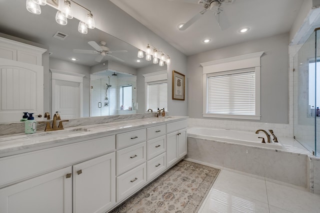 full bathroom featuring tile patterned floors, a sink, visible vents, and a shower stall