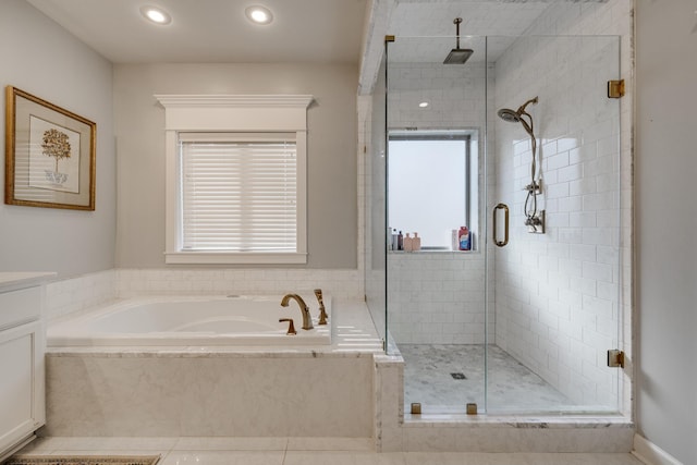 bathroom featuring a garden tub, a shower stall, vanity, and recessed lighting