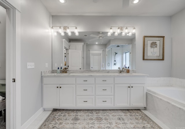 full bathroom with double vanity, a stall shower, ceiling fan, a sink, and tile patterned flooring