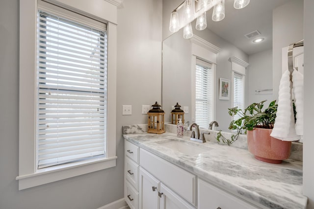 bathroom with vanity and visible vents