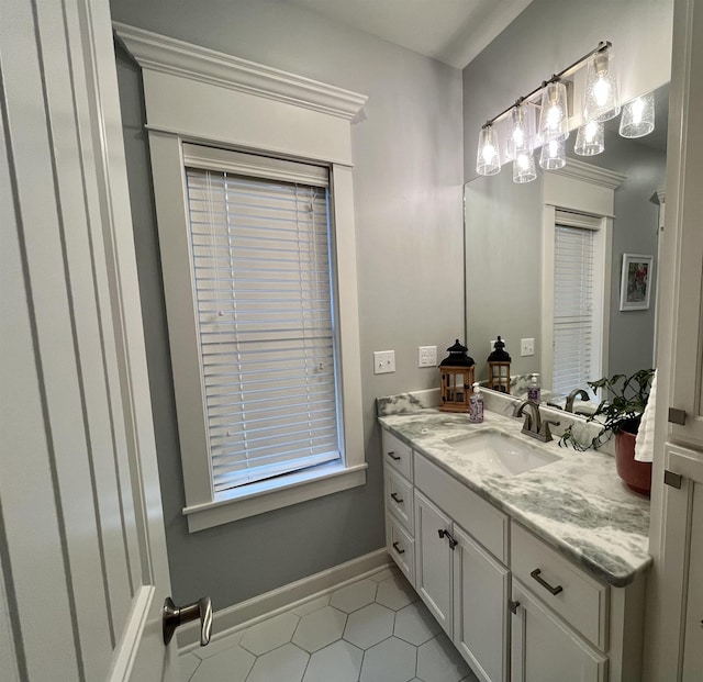 bathroom with vanity, baseboards, and tile patterned floors