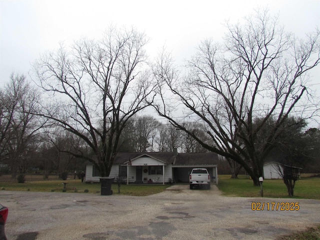 view of front of property featuring a garage and a front lawn