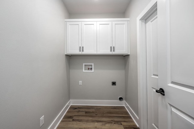 clothes washing area with dark wood-type flooring, washer hookup, cabinets, and electric dryer hookup