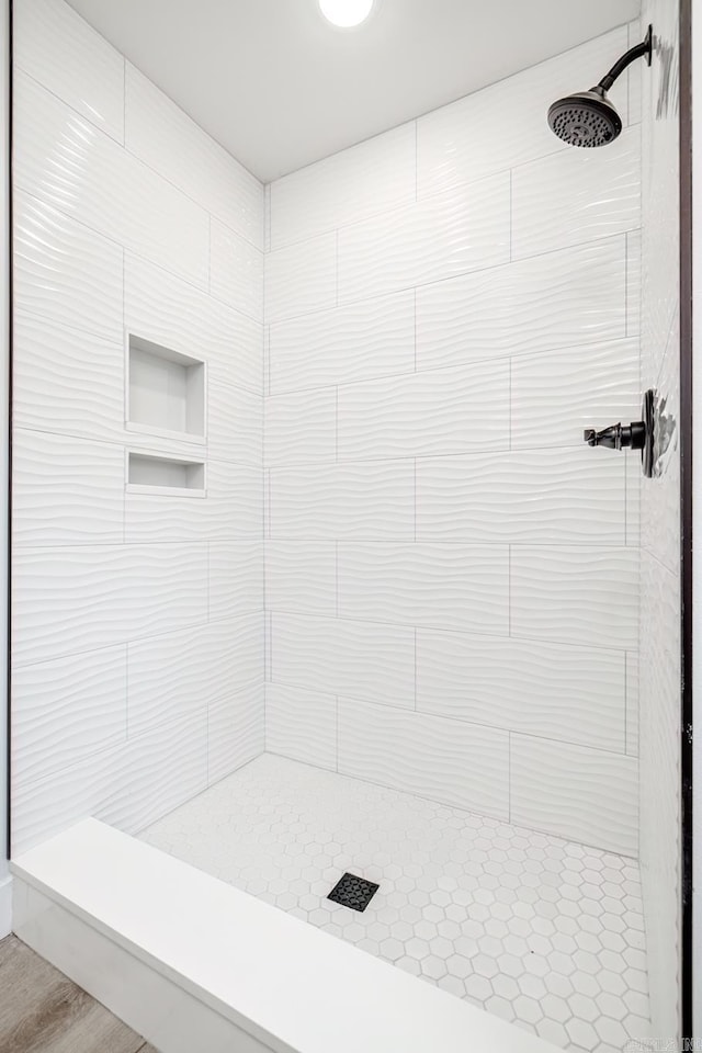 bathroom with tiled shower