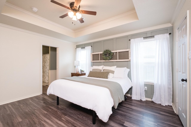 bedroom featuring ceiling fan, crown molding, dark hardwood / wood-style flooring, and a raised ceiling