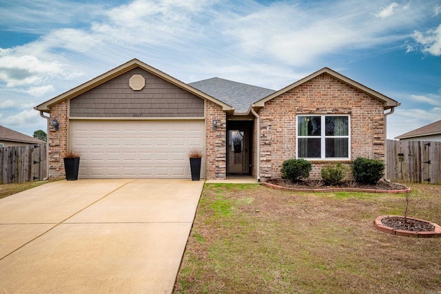 view of front of home with a front yard and a garage