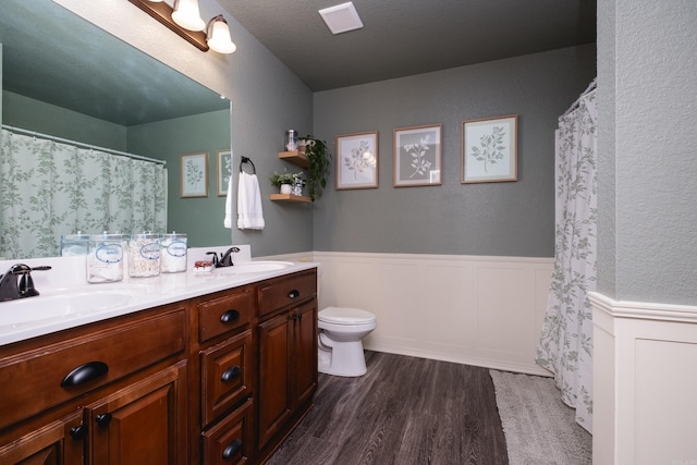 bathroom featuring hardwood / wood-style floors, toilet, and vanity