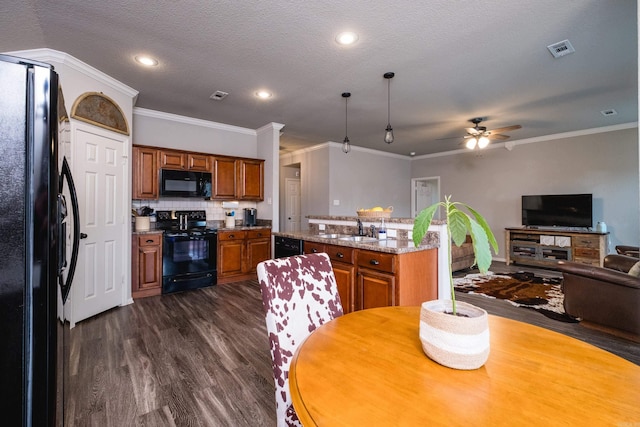 kitchen featuring light stone countertops, black appliances, backsplash, dark hardwood / wood-style flooring, and sink