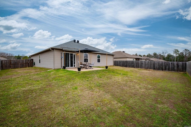 rear view of house with a patio area and a lawn