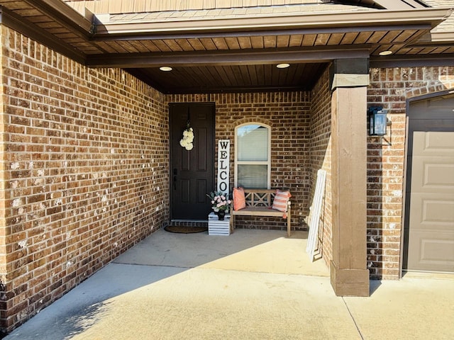 doorway to property with a garage