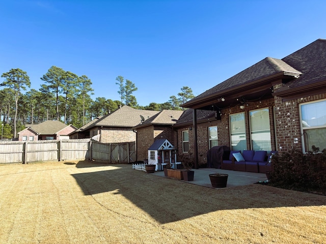 back of house featuring a yard and a patio area