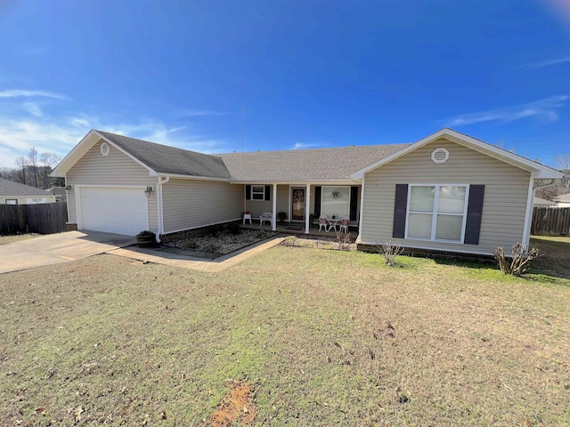 ranch-style home featuring a garage, covered porch, and a front yard