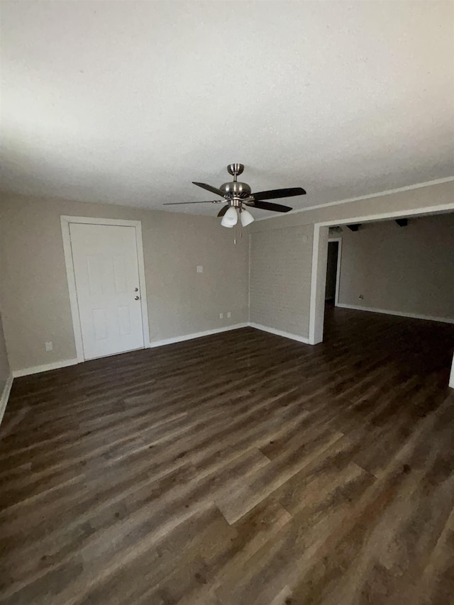 spare room featuring ceiling fan and dark hardwood / wood-style flooring