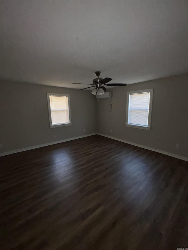 empty room featuring dark hardwood / wood-style flooring and ceiling fan