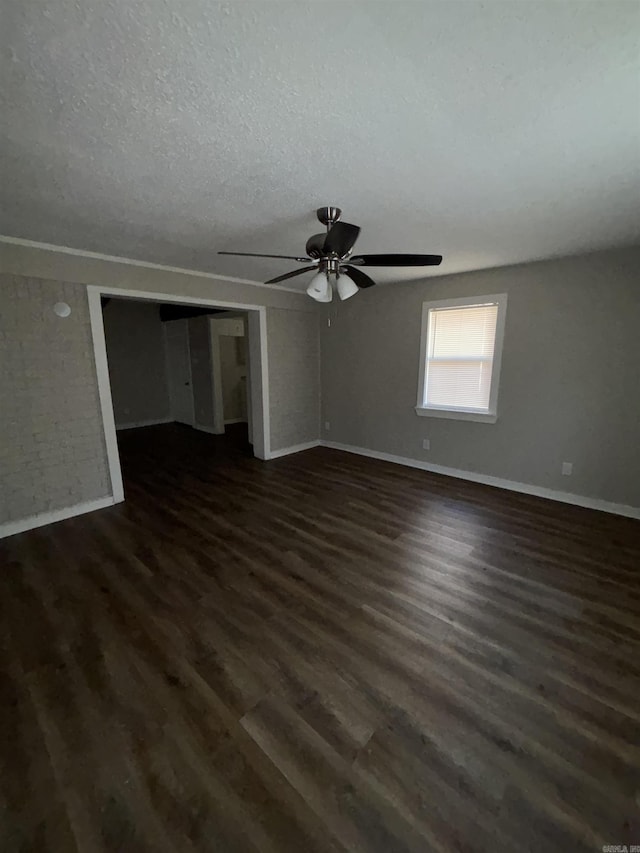 unfurnished room with ceiling fan, dark hardwood / wood-style flooring, and a textured ceiling