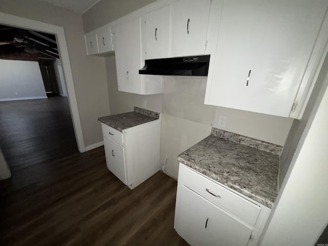 kitchen featuring dark hardwood / wood-style floors and white cabinets