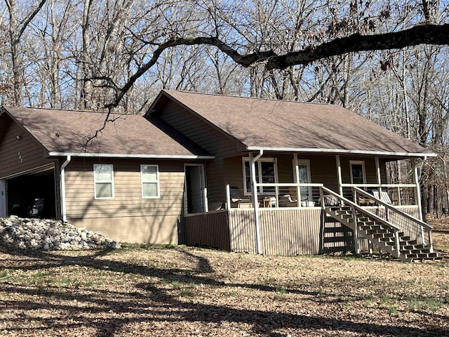 ranch-style house featuring a garage and a porch