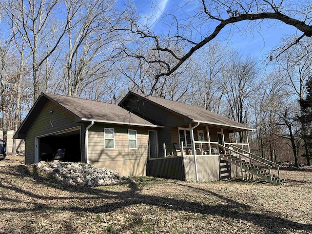 view of side of home with a porch and a garage