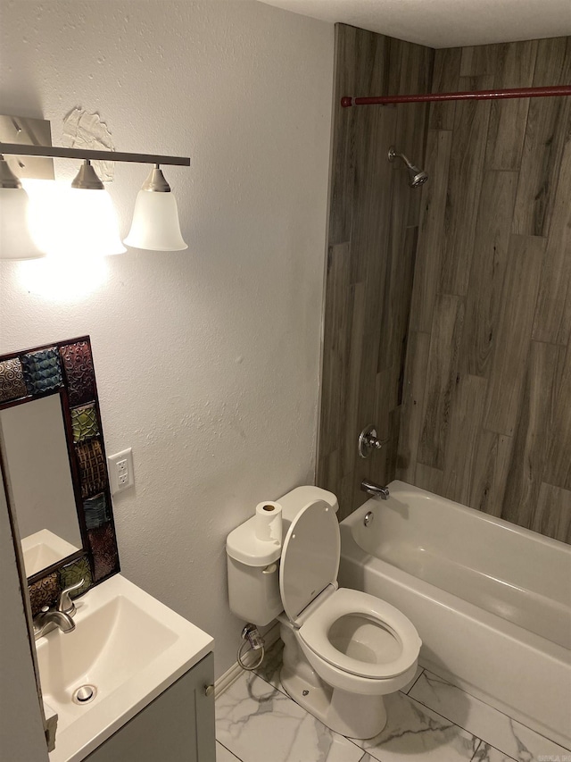 full bathroom featuring vanity, tiled shower / bath, and toilet