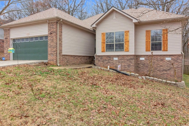 view of home's exterior with a garage, driveway, brick siding, and a lawn