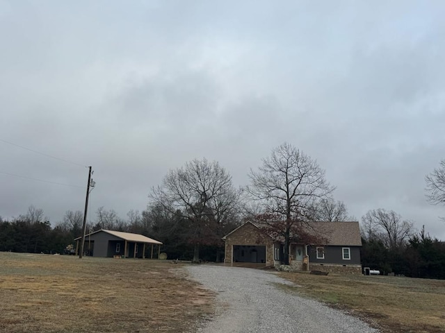 view of front of house with gravel driveway and an attached garage