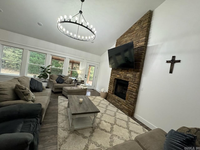 living area featuring a fireplace, an inviting chandelier, wood finished floors, high vaulted ceiling, and baseboards