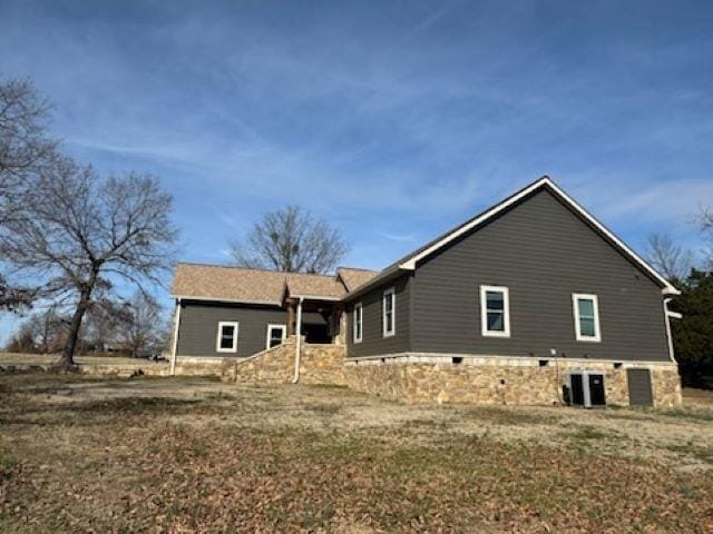 view of side of home with central AC unit