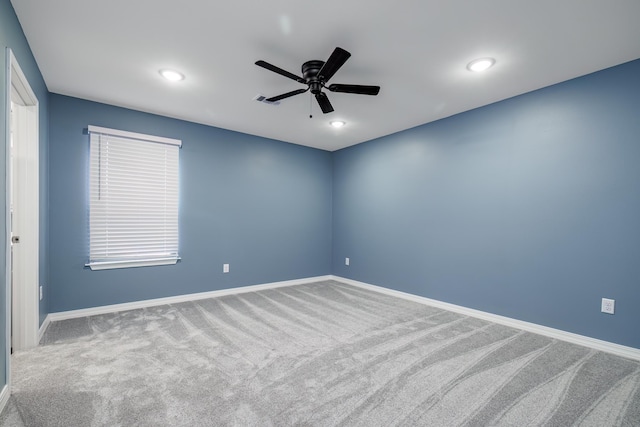 empty room with ceiling fan and carpet floors