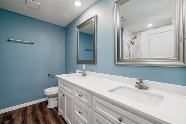 bathroom with hardwood / wood-style flooring, vanity, and toilet