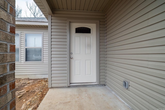 view of exterior entry featuring a patio area