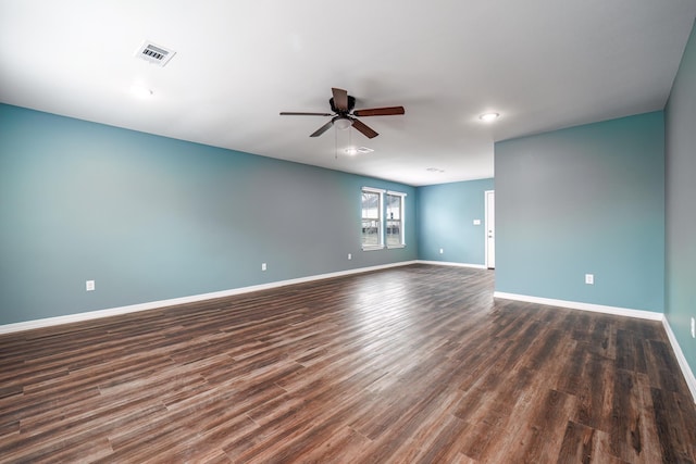 spare room featuring ceiling fan and dark wood-type flooring