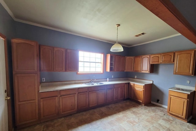 kitchen featuring crown molding, sink, and decorative light fixtures