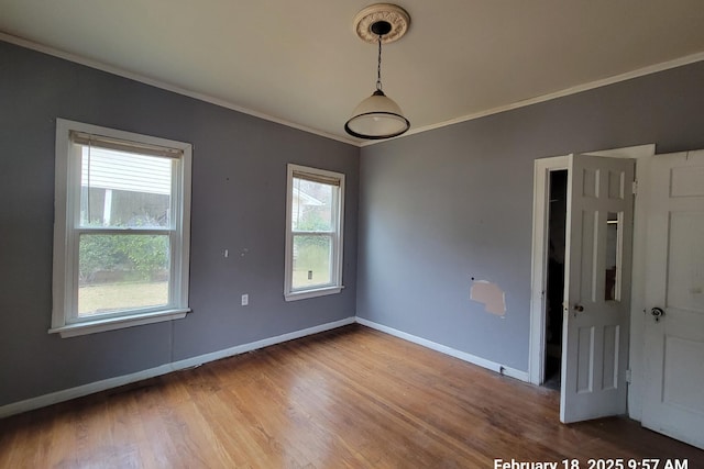 unfurnished room featuring hardwood / wood-style flooring and crown molding