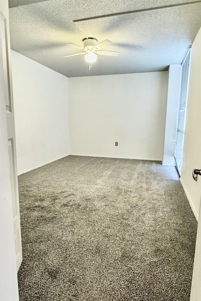 spare room featuring ceiling fan, carpet floors, and a textured ceiling