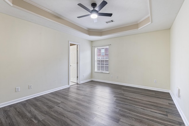 spare room with ceiling fan, crown molding, dark hardwood / wood-style flooring, and a raised ceiling