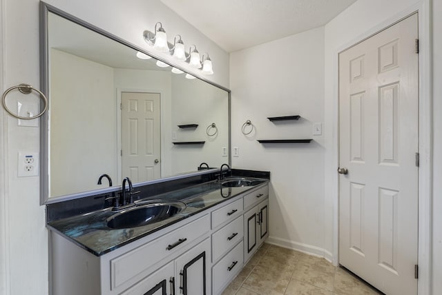 bathroom with tile patterned floors and vanity