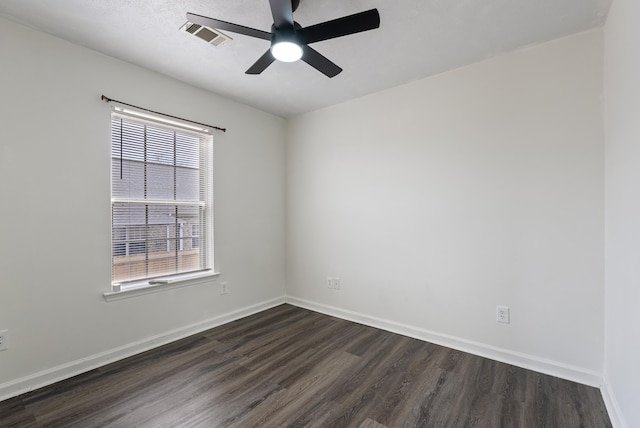 spare room with ceiling fan and dark hardwood / wood-style flooring