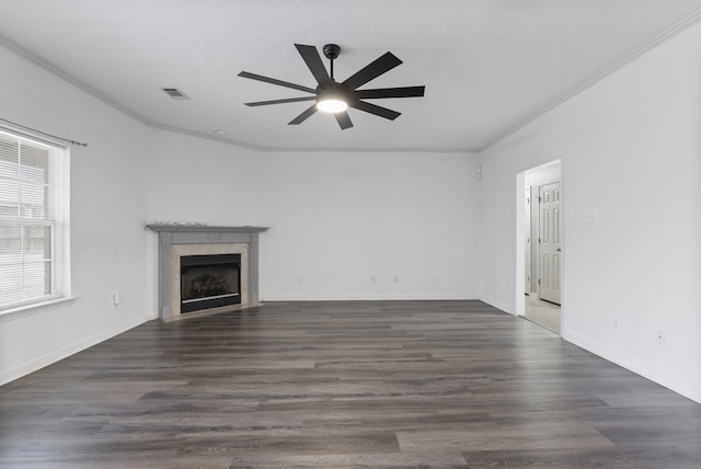 unfurnished living room featuring ceiling fan, crown molding, dark hardwood / wood-style floors, and a tiled fireplace