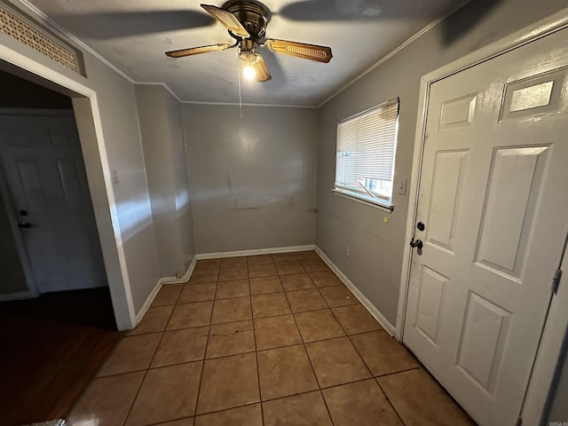 interior space with ceiling fan and crown molding