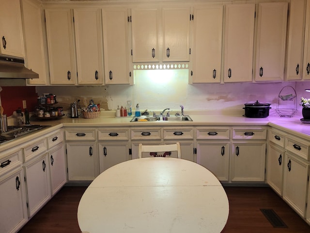 kitchen featuring sink, dark wood-type flooring, white cabinets, and gas stovetop